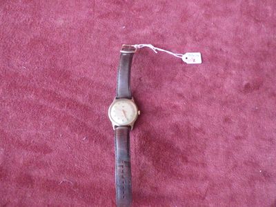 a watch that is laying on a red surface