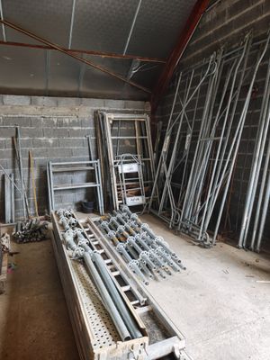 a room that has a bunch of metal pipes and ladders in it