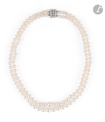 a double strand pearl necklace with a diamond clasp