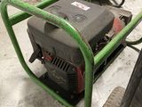 a green cart with a generator on it in a garage