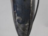 a silver cup that is sitting on a table
