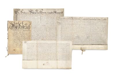 a group of three old papers sitting on top of each other