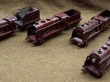 four toy trains sitting on a table next to each other