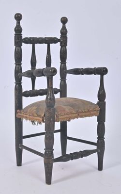 a black chair with a brown seat and a brown cushion