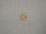 an image of a close up of a piece of cloth with a gold emblem on it