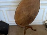 a wooden table with a mirror on it in a room