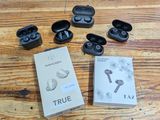 a box of true wireless earphones on a wooden table