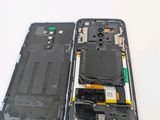 a broken cell phone sitting on a white table