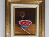 painting of a bowl of cherries on a table with a glass of wine in the background