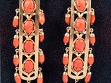 an image of a pair of earrings with coral beads