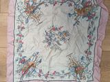 pink and blue floral handkerchief with birds on it on a wooden floor