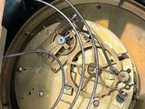 a close up of a clock with wires attached to it