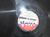 a black record with a red and white label on it