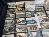 a lot of old postcards that are on a table
