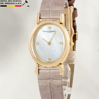 an image of a woman ' s wrist watch with a mother of pearl dial