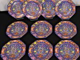 six colorful plates with designs on them on a black surface