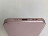 a close up of the back of a pink iphone with a finger on it