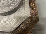 a silver plate sitting on top of a wooden table
