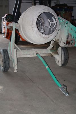cement mixer in a warehouse with a hose attached to it