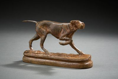 statue of a dog running on a wooden base on a gray surface