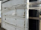 a white container sitting on a pallet in a parking lot