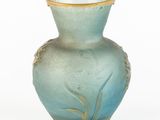 a blue vase that is sitting on a white surface