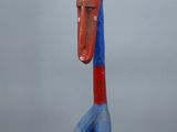 a close up of a sculpture of a bird on a wooden base
