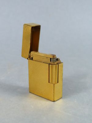 a gold lighter that is sitting on a table