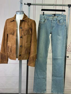 a mannequin with a jacket and jeans on a stand