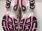 adidas running shoes with pink and black soles on a white surface