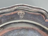 a silver plate with a crest on it