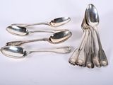 five spoons that are sitting on a white surface