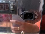 a close up of a microwave with a digital clock on it