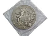 a silver coin in a plastic bag on a white surface