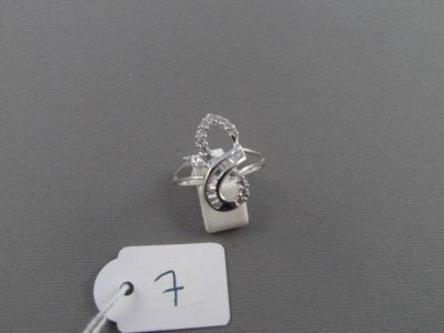 une bague en argent ornée d'un cœur, à côté d'une étiquette de prix