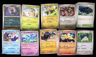 several pokemon cards are lined up on a black surface