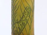 a yellow vase with a drawing on it on a table