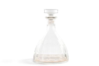 a clear glass bottle with a small amount of liquid in it