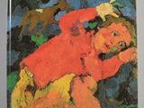 un livre sur lequel figure l'image d'un enfant portant un t-shirt rouge