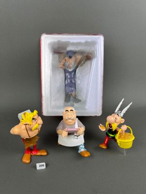 three figurines of cartoon characters in a box on a table