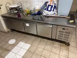 a kitchen with a stainless steel counter top and a sink
