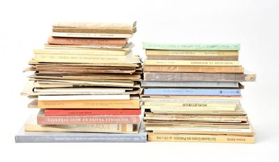 many books stacked on top of each other on a table