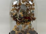 a glass clochet with a bunch of flowers inside of it