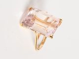 an image of a gold ring with a pink stone on it