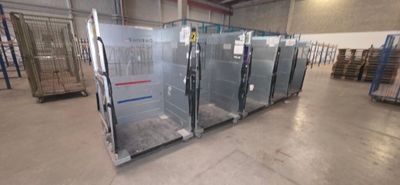 many glass doors in a warehouse with pallets on the floor