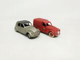 two toy cars sitting next to each other on a white surface
