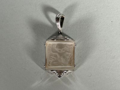 silver pendant with a picture of a woman on it