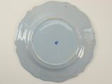a plate with a blue flower on it on a table