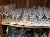 a wooden cabinet with a bunch of wine glasses on it