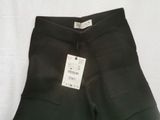 the back of a pair of black pants with a tag on it